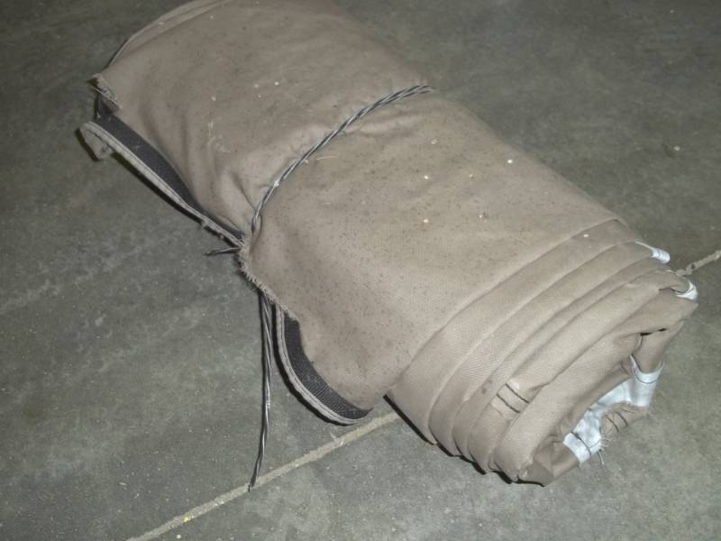 lot 121 image: Brown Wood Pile tarp may have some cuts or holes