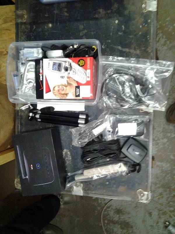 lot 53 image: Old Verizon Phones, Modems, Polaroid Digital Camera, Tripods, More