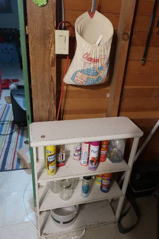 SMALL WHITE SHELF WITH CLEANERS AND VINTAGE CLOTHES PIN HOLDER