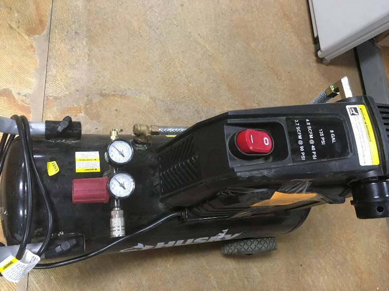 lot 102 image: Husky 8 Gal Portable Oil Free Electric Air Compressor  in like New working conditions