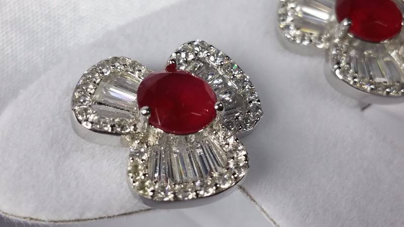 lot 24 image: Ruby and White Topaz Earrings