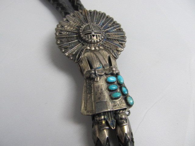 lot 102 image: Signed THOMAS BYRD Navajo Sterling Silver Kachina Bolo Tie