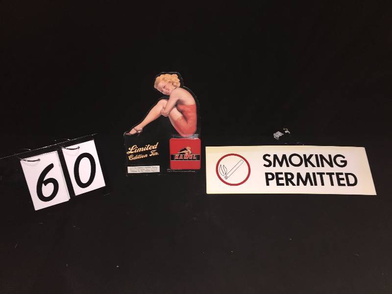 lot 60 image: Kamel Cigarettes Limited Edition tin with pin-up girl display and Smoking Permitted sign