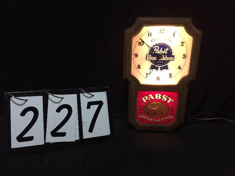 lot 227 image: Pabst Blue Ribbon Beer lighted clock with pendulum