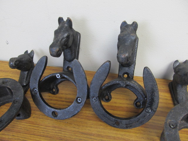 lot 17 image: 4 Cast Iron Horse Head Wall HangersHooks