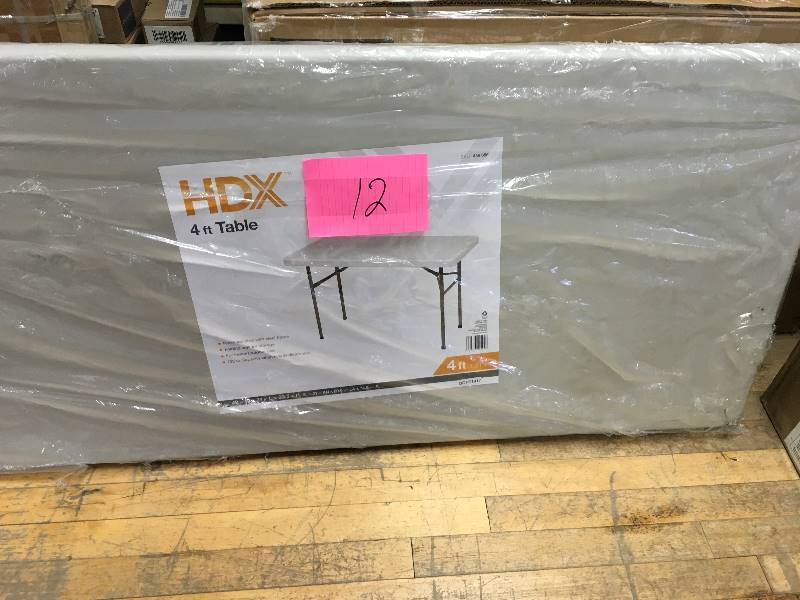 lot 12 image: HDX 4 ft Folding Table not used