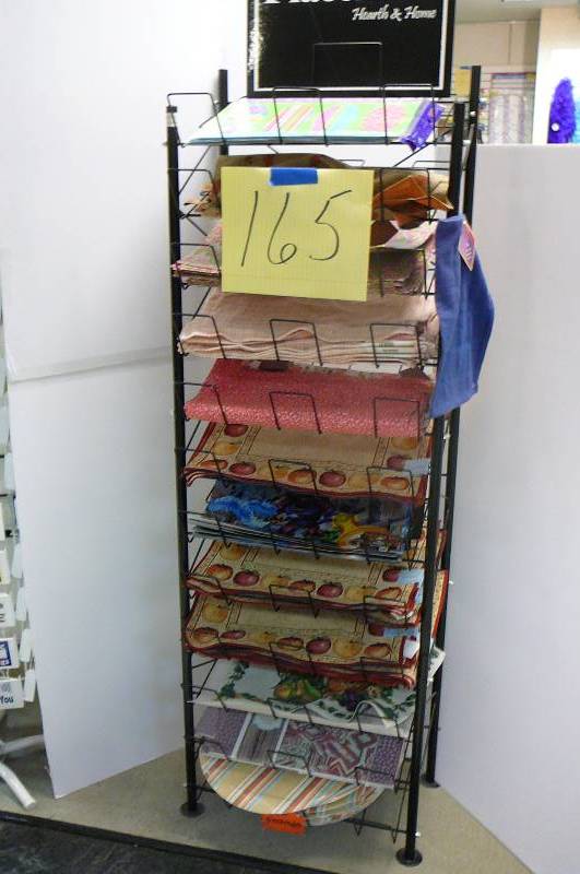 lot 165 image: Misc. paper, plastic and cloth placemats, rack included