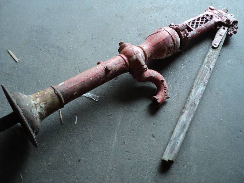 lot 36 image: cast iron pump with wood handles, v...