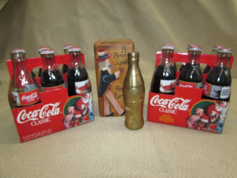 lot 149 image: COCA-COLA HOLIDAY BOTTLES, BRASS COKE BOTTLE AND WOODEN BANK