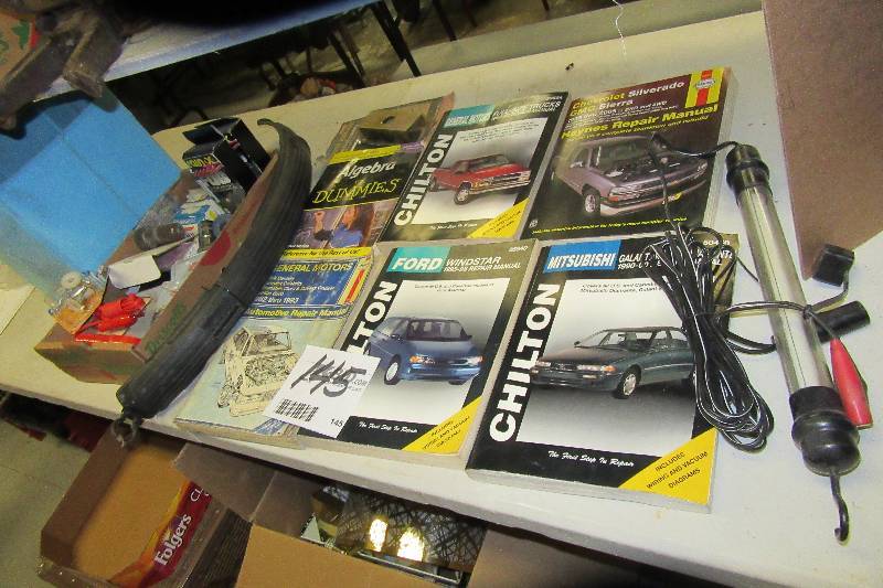 lot 145 image: Auto repair books  LED work light, Misc. .items in the box