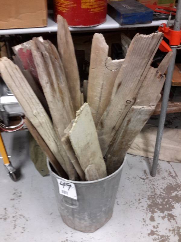lot 49 image: Garbage can full of weathered wood.. Includes can