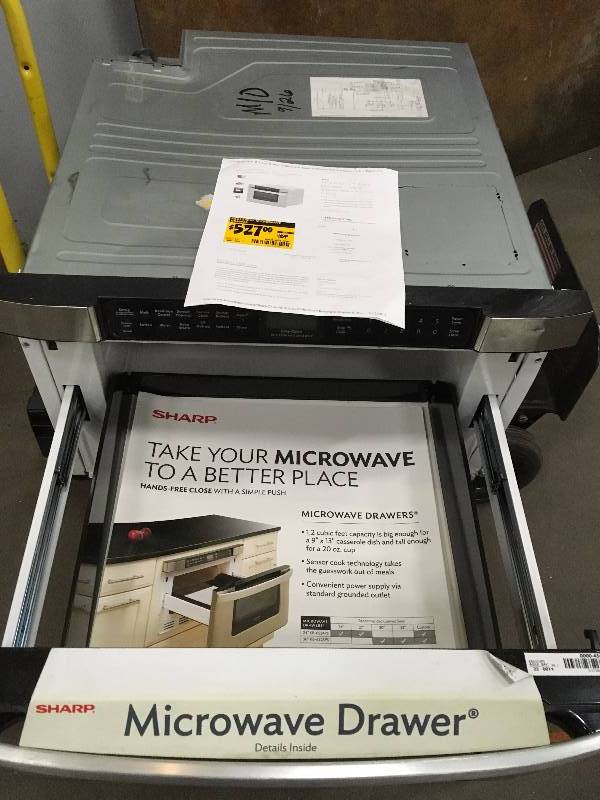 lot 83 image: Sharp 24 in. W 1.2 cu. ft. Built-in Microwave Drawer in Stainless Steel with Sensor Cooking retail $1400 whit small damage on the corned