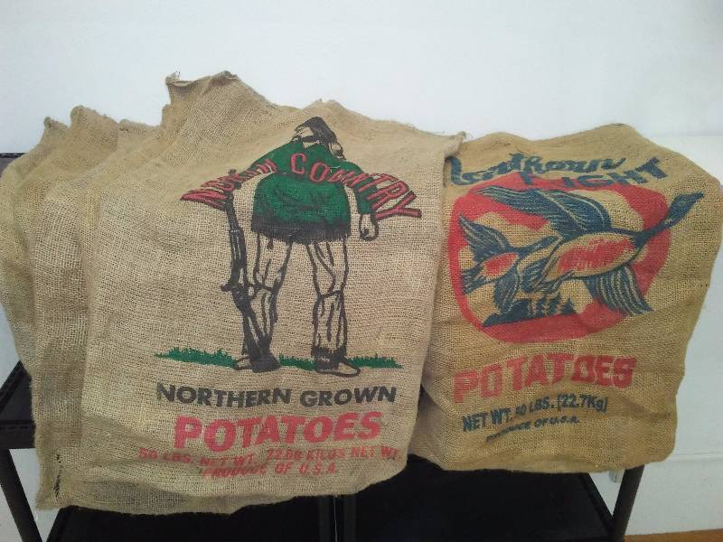 lot 3 image: 50 Pound Burlap Potatoes Sacs (6) North Country (5) and Northern Flight (1)