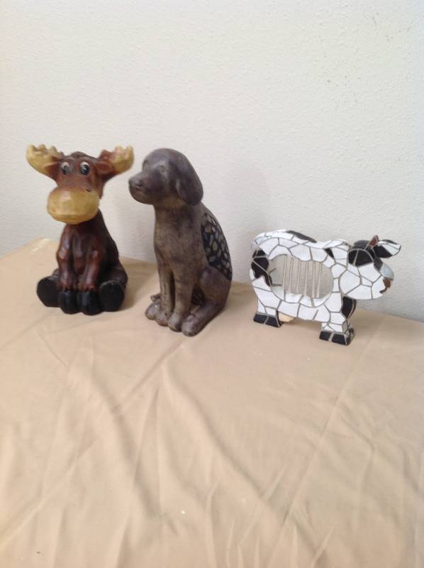 lot 32 image: Bobble-head moose, dog statue and cow wind chime.