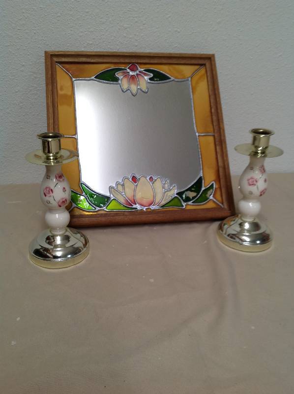 lot 46 image: Floral mirror, two candle sticks and hanging candle.