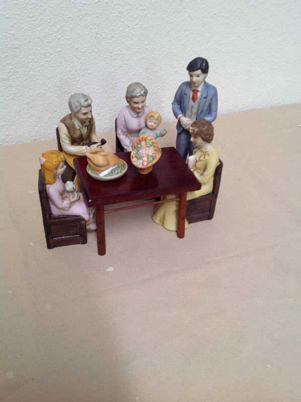 lot 47 image: 8 Ceramic Family setting around wooden table.