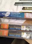 lot 104 image: 8 -Heavy Duty Overhead Door Stop, 2 Pleated Shades, 36 by 72 and, 2 Door Sweeps 36 Inch