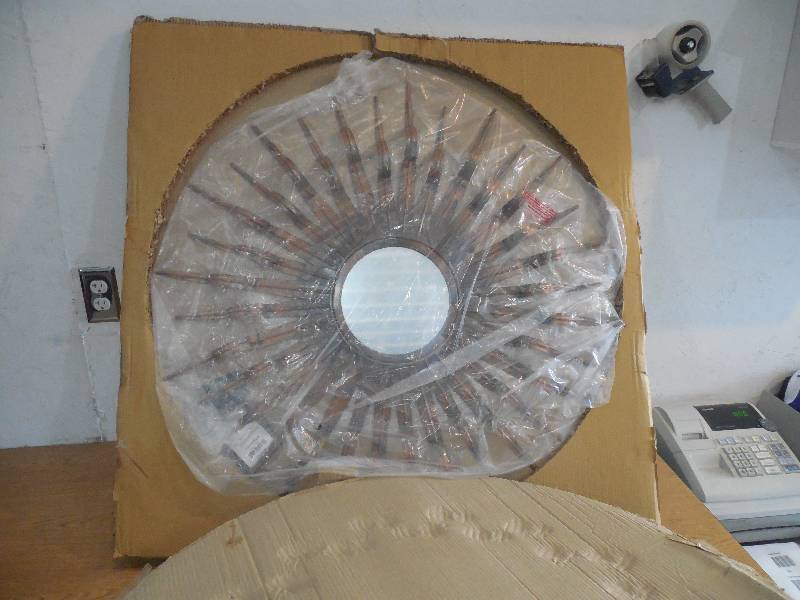 lot 81 image: Safavieh Sun 33.1 in. x 33.1 in. Iron and Glass Framed Mirror