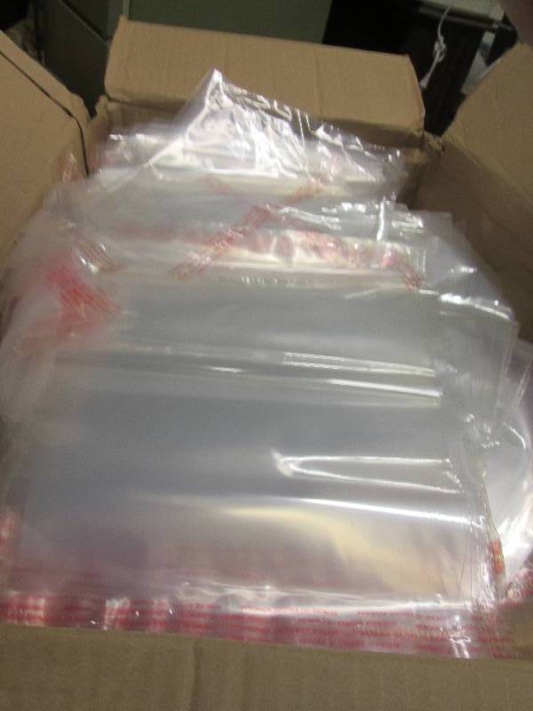 lot 144 image: case of plasteic sleeve bags paper ...