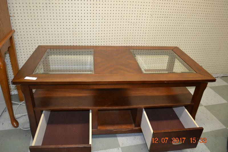 lot 57 image: Coffee Table with Glass on top on rollers 2 drawers go out both sides