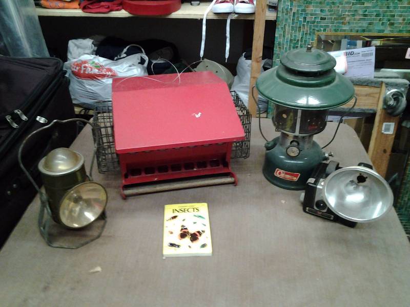 lot 14 image: Coleman Lantern, Other Lantern, Bird Feeder, Old Camera, Insect Book