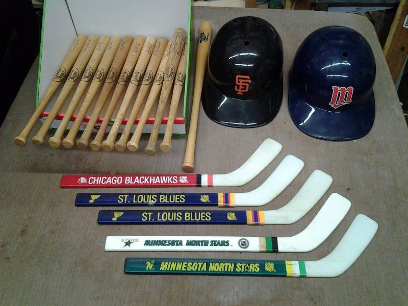 lot 32 image: Collectible Mn. Twins Mini Bats, (Puckett, Hrbek, Brunansky, Gaitti), Batting Helmets, Mini Hockey Sticks
