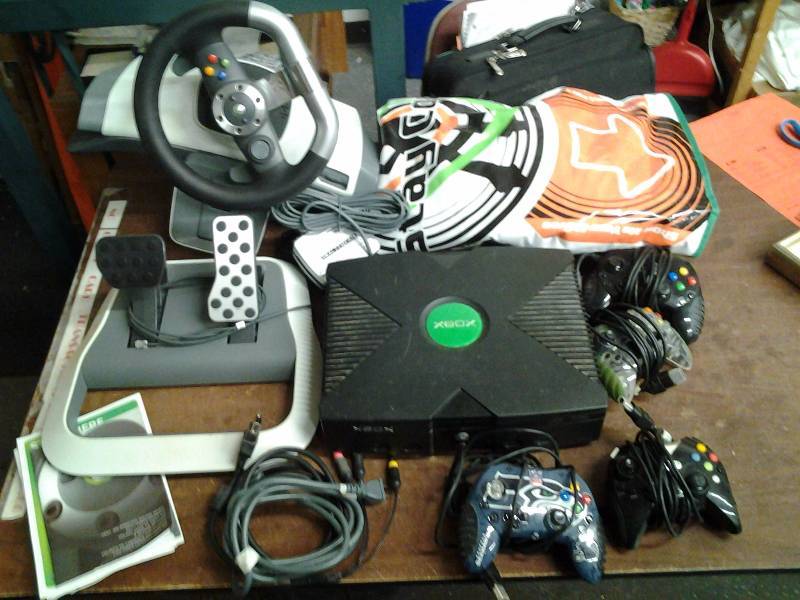 lot 34 image: X Box Console, Controllers, Cords. X Box 360 Steering Wheel, Foot Pedals. Dance Pad
