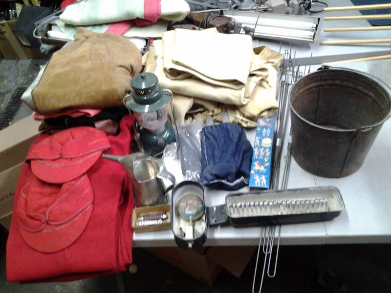lot 27 image: Coleman Lantern, Tent Stakes, Pocket Knives, Campfire Roasters, Wool Clothing, Tanned Deer Hides, Chicken Waterer, Misc