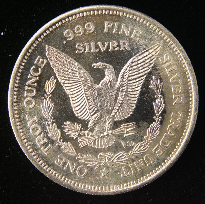 lot 92 image: 1 TROY OZ. .999 FINE SILVER 1985 MORGAN DOLLAR DESIGN