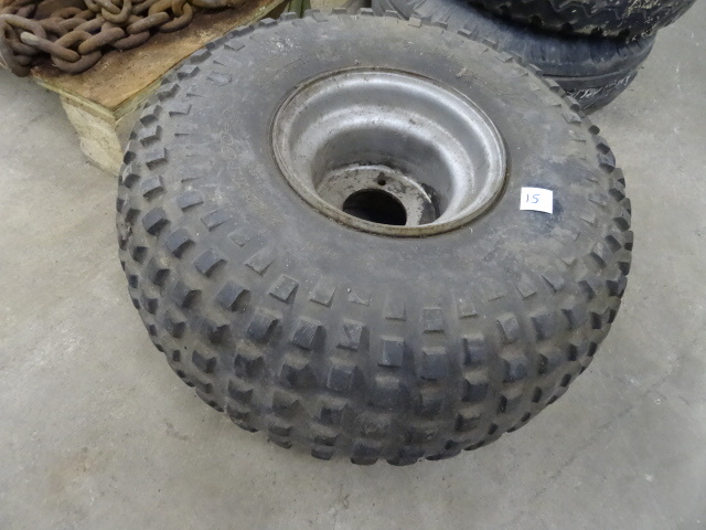 lot 15 image: 4 wheeler tire and rim. 22 x 11 - 8...