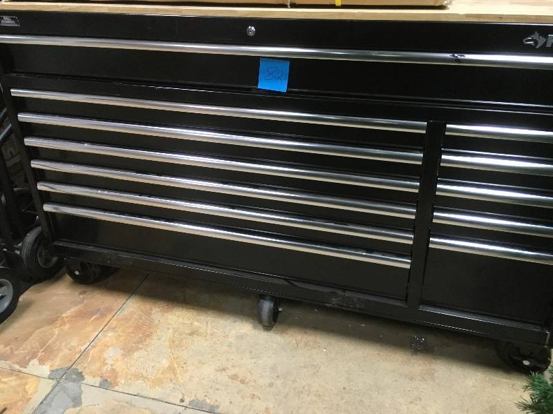 lot 82 image: Husky 66 in. W 24 in. D 12-Drawer Heavy-Duty Mobile Workbench, Black not used whit damage on the side