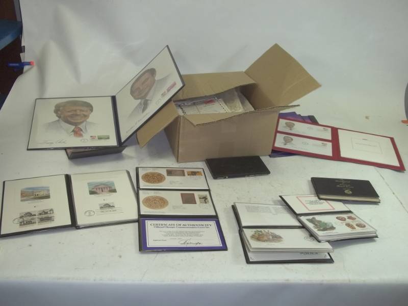 First Day Issue stamps with folders and box of stamps