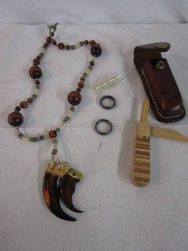 lot 53 image: knife, necklace, gold flakes and rings