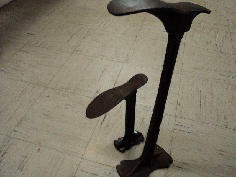 lot 11 image: 2 cast iron shoe holders, one is 23...