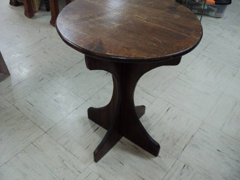 lot 22 image: round wood side table...