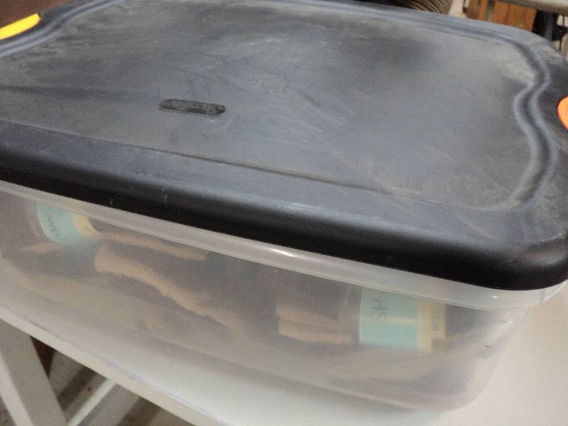 lot 23 image: covered tote full of dish cloths an...