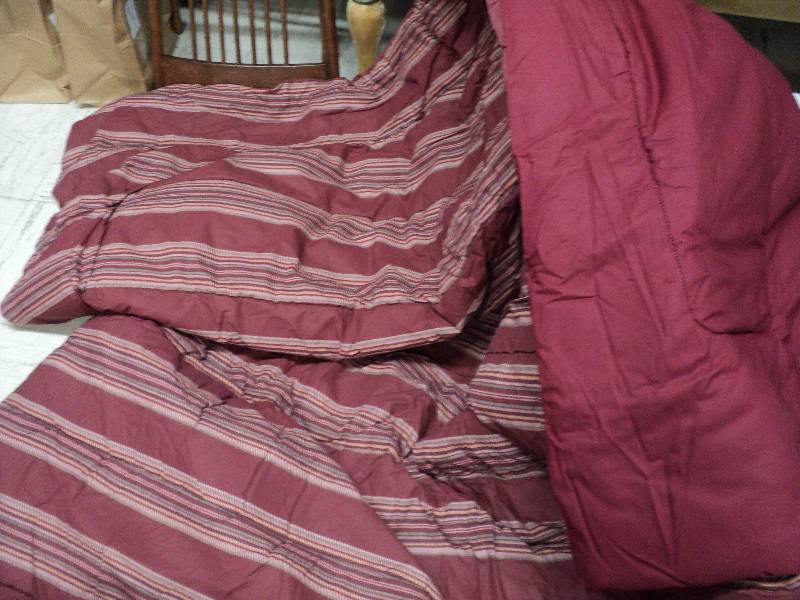 lot 136 image: full size comforter in covered tub...