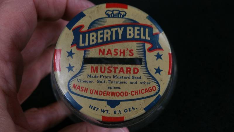 lot 48 image: Vintage Nashs Mustard Liberty Bell Coin Bank