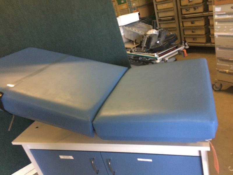 lot 53 image: Awesome Multi-Use Doctor Medical Clinic Ob-Gyn Bed Exam Table with Stirrups Perfect for Tatoos Versatile Positions and Storage Excellent Condition