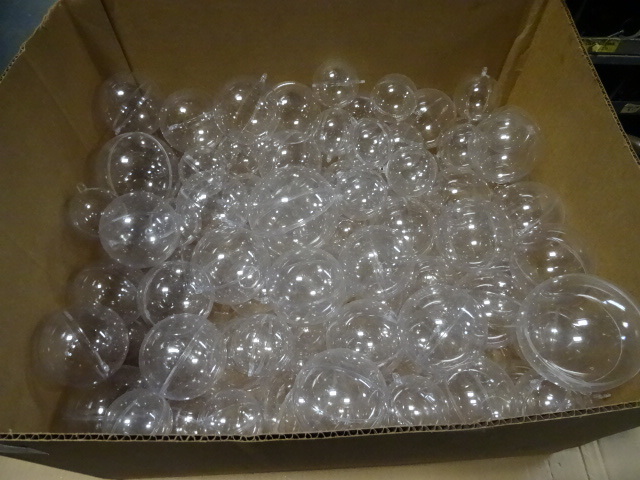Box full of clear plastic balls wit...