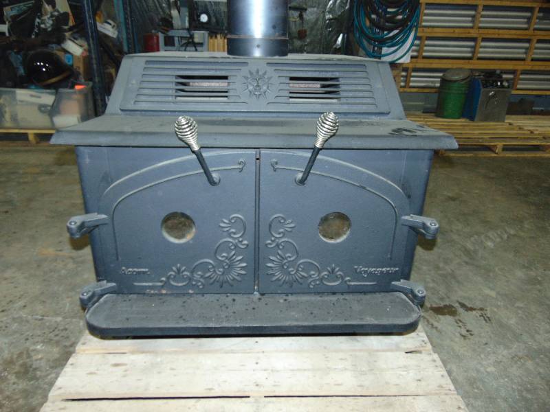lot 23 image: Warnock Hersey Wood Stove With Blower Fan and Some Pipe