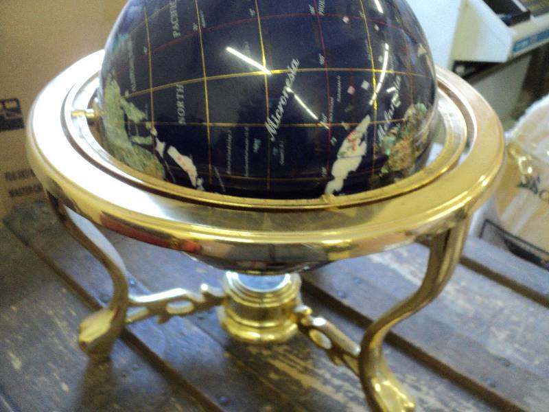 lot 75 image: Rotating globe in gold stand...