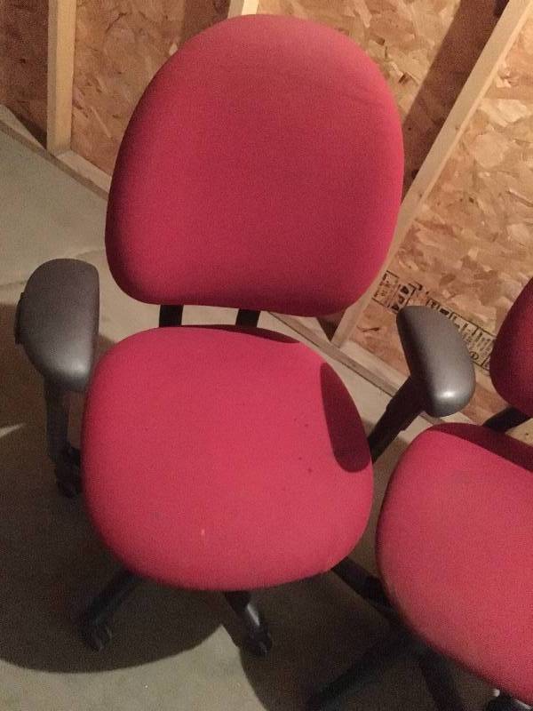 Three red office chairs
