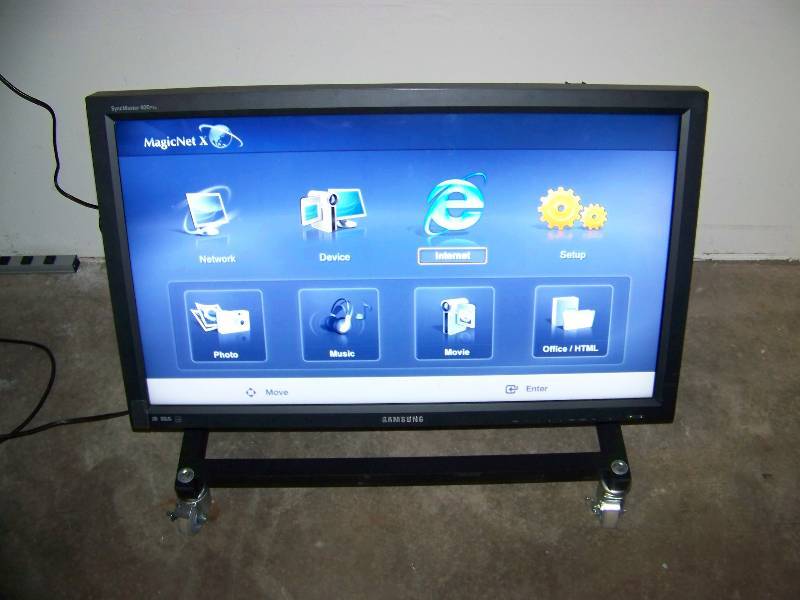 lot 18 image: 40, Samsung, LCD, Monitor  Display on Low, Rolling Cart with Tilting Mount  Frame