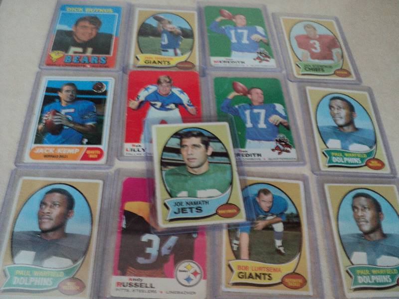13 football cards in sleeves from 1...