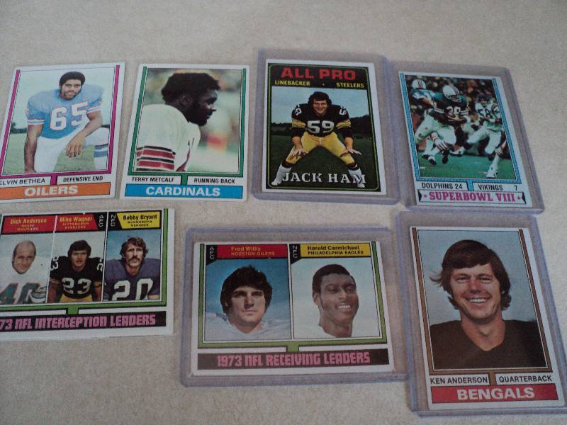 7 football cards in sleeves from 19...