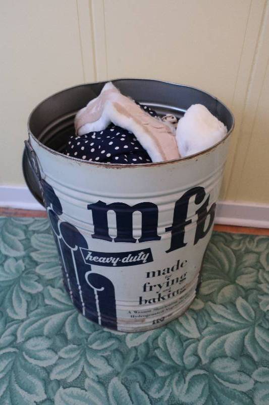 lot 132 image: LARD TIN WITH VINTAGE CLOTHES