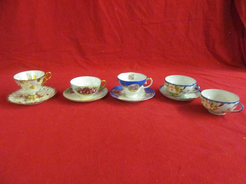 lot 76 image: fancy cups, saucer sets