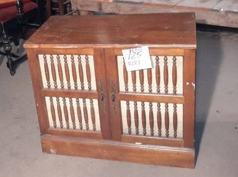 lot 125 image: wood cabinet with spindle design on front