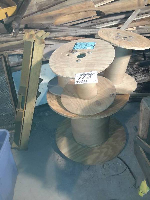 lot 178 image: Misc. Wire spools.  2, behind the pew book shelves